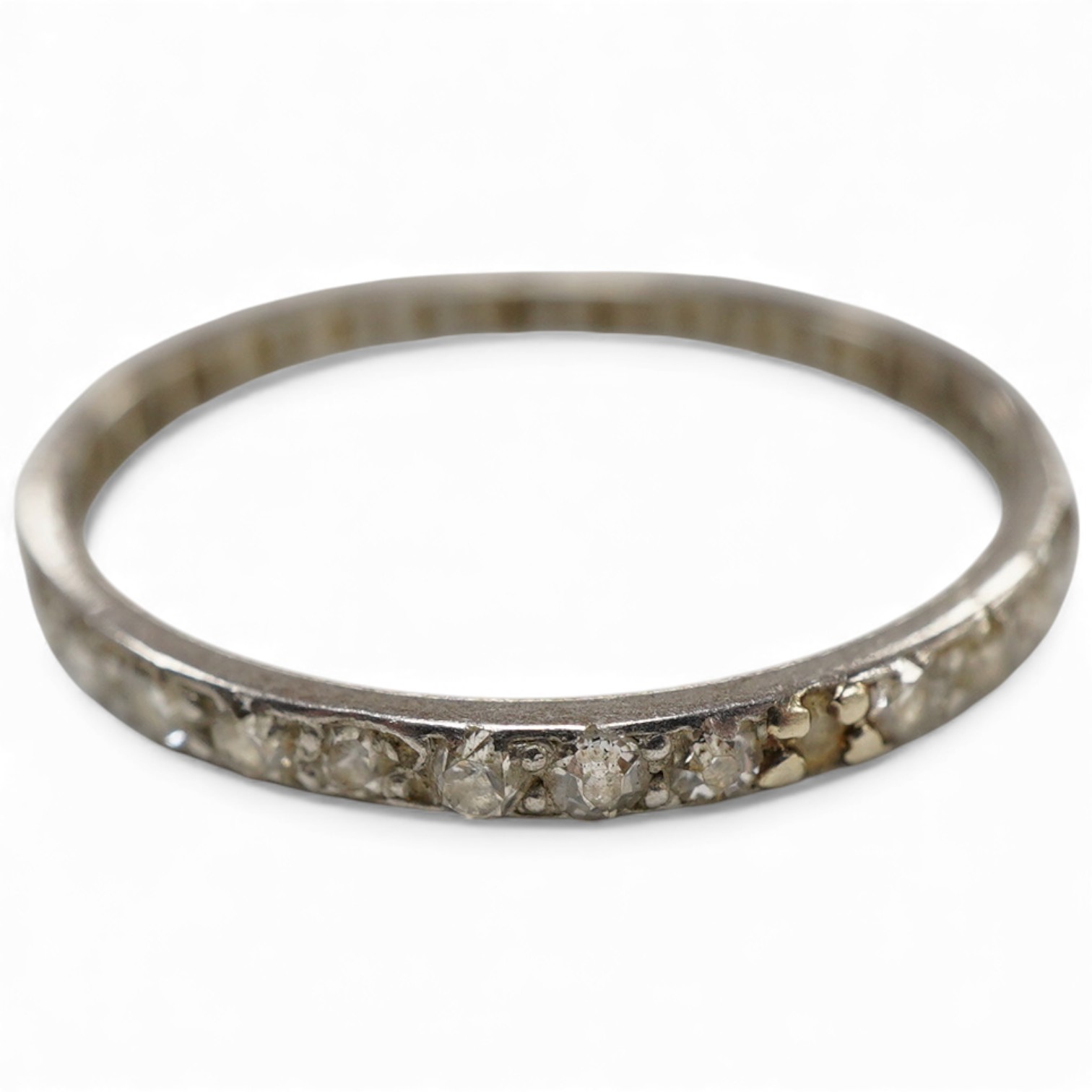 A white metal and diamond chip set full eternity ring, size O.